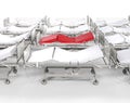 Row of hospital white beds - red stands out