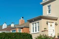 Row of house detail facades with front or back door visible on brown stuco house with white accents and orange building Royalty Free Stock Photo