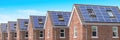 Row of house with solar panels on roof  on blue sky background Royalty Free Stock Photo