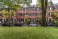 Row houses along a street with a garden in foreground Royalty Free Stock Photo