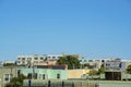 Row of houses and apartment building with decorative colors and copy space in blue sky background in midday sun Royalty Free Stock Photo