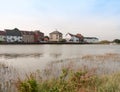 Row of houses coast marina dock other side of river