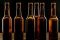 Row of ice cold unlabelled brown beer bottles