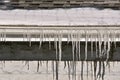 Row of icicles hang from a building