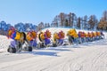 Row of idle snow guns cannons branded Latemar, from TechnoAlpin, lined up on a ski slope in Val di Fassa domain, Dolomites. Royalty Free Stock Photo