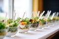 row of individual salad servings for a catering event