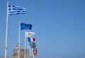 Row of International Flags, with the Greek Flag in the Front, Against the Blue Sky on Rhodes Harbor Royalty Free Stock Photo