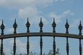 A row  iron sharp rods on a black  wall of a metal fence Royalty Free Stock Photo