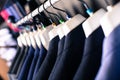 Row of jackets on hangers in men clothing store Royalty Free Stock Photo