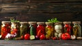 A row of jars filled with a variety of vegetables including pickles, peppers, and carrots