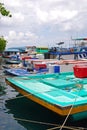 A row of large fishing vessel boat boats docking nearby the fish market at Male Maldives