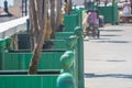 A row of large green outdoor flower pots made of wood runs straight down the street. At the top point in each corner there is a Royalty Free Stock Photo