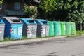 Italy , Rome , 17 March 2020 : Row of large green wheelie bins for rubbish, recycling and garden waste