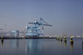 Row of large harbor cranes in the rotterdam harbor