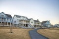 Row of large houses with curved paved road at the front