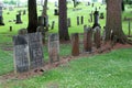 Several rows of large headstones and memorials honoring residents under shady trees, Oakwood Cemetery, Chittenango, New York, 2018