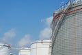 Row of large white tanks for petrol and oil