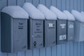 Letterboxes in front of a home in winter