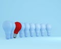 Row of light bulbs red one different idea from the others on light blue background