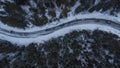 Row or line of cars ligned one after another on an icy and snowy road in norway in sweden meandering around the trees. Vertical Royalty Free Stock Photo