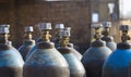 Row of liquefied oxygen industrial gas containers with valves. Close up of valves Royalty Free Stock Photo