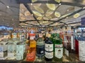 A row of liquor bottles on a shelf, including a green bottle of Burnette