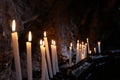 Row of lit candles on offer to the cult of the Virgin Mary