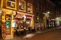 Row of local steakhouses and restaurants at night in red-light district in Amsterdam, the Netherlands. Royalty Free Stock Photo