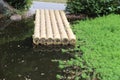 A row of logs floating on a pond Royalty Free Stock Photo