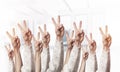 Row of man hands showing victory gesture Royalty Free Stock Photo