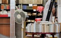 Row of many old used books displayed at local antiquarian bookshop, blurred person and more shelves background Royalty Free Stock Photo