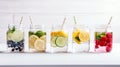 A row of mason jars filled with vibrant fruit-infused water.