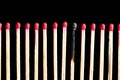 Row of matches with one burned Royalty Free Stock Photo