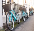 Row of matching rental student bicycles with baskets