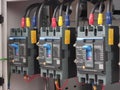 A row of mccb mount on electrical switchboard in factory. Mould Case Circuit Breaker. Royalty Free Stock Photo