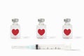 Row of medical vials of injectable medicine with floating hearts and hypodermic needle