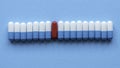 A row of medicine pills with a single red pill in the middle Royalty Free Stock Photo
