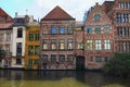 Row of medieval colored buildings along Lys River dutch: Leie Spring landscape photo.