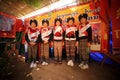 Row of Mein or Yao Hill Tribe standing embroidery of traditional dresses.