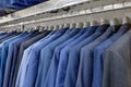 Row of men`s suit jackets hanging on hangers Royalty Free Stock Photo