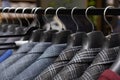 A row of men\'s suits, jackets hanging on a rack for display Royalty Free Stock Photo