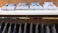 Row of men suit jackets on hangers and shelf with shirt Royalty Free Stock Photo