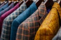 A row of men& x27;s suits on hangers in a clothing boutique. Elegant suit jackets of different colors and textures Royalty Free Stock Photo