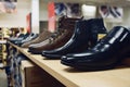 A row of Mens dress shoes on shelf