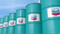 Row of metal barrels with Chevron Corporation logo against sky, editorial 3D rendering