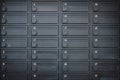 A row of metal deposit boxes or mail boxes in a dark grey colour in an apartment Royalty Free Stock Photo