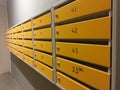 Row of metal yellow apartment mailboxes