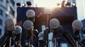 Row of microphones set up in front of a blurred background, likely indicating a press conference Royalty Free Stock Photo