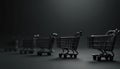 Row of miniature black shopping carts on dark gray surface. Empty trolleys lined up on matte backdrop. Retail, commerce, Royalty Free Stock Photo
