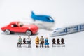 row of miniature people figure sitting on bench with air plane,car,hispeed train model figure background Royalty Free Stock Photo